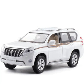 White die-cast toyota prado suv model with silver accents and tan interior trim.