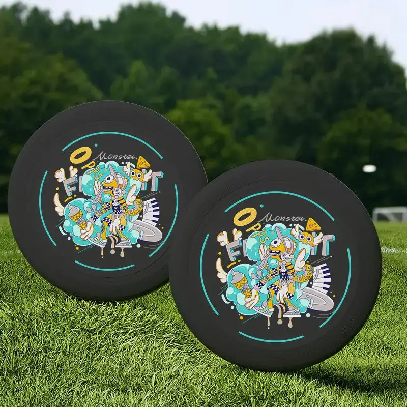Black frisbees with colorful cartoon monster designs and teal accents.