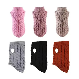 Knitted dog sweaters in pink, mauve, beige, gray, black, and rust with a cable-knit pattern and heart-shaped cutouts.
