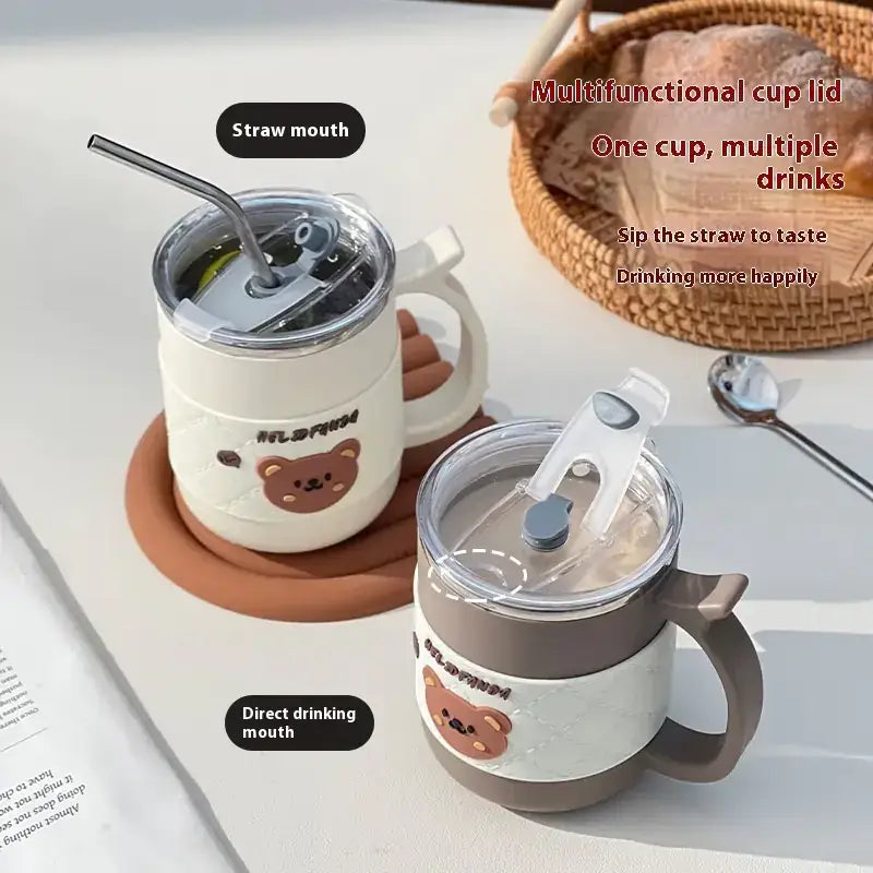 Cream-colored insulated mug with a brown bear face design and two drinking options: one with a straw mouth for sipping, the other with a direct drinking mouth.