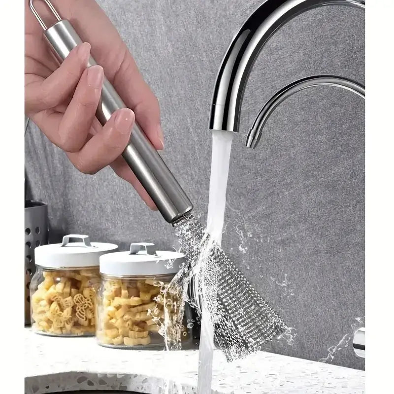 A sleek, stainless steel kitchen cleaning brush with a polished handle and a fine mesh head.