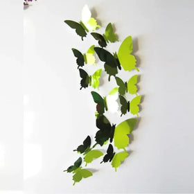 A set of glossy, three-dimensional butterfly wall decals in varying shades of green and black.