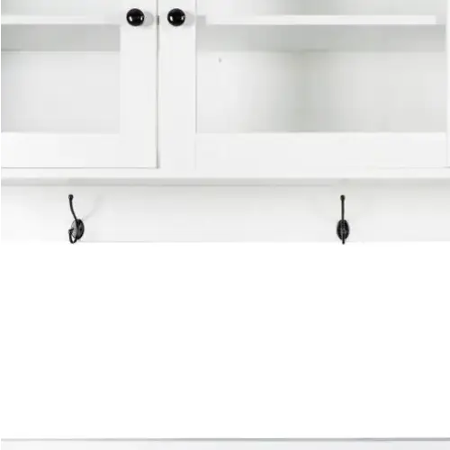 White cabinet with black knobs and two matching black hooks below.