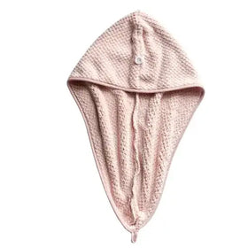 A soft pink, textured microfiber towel with a hood and button closure.
