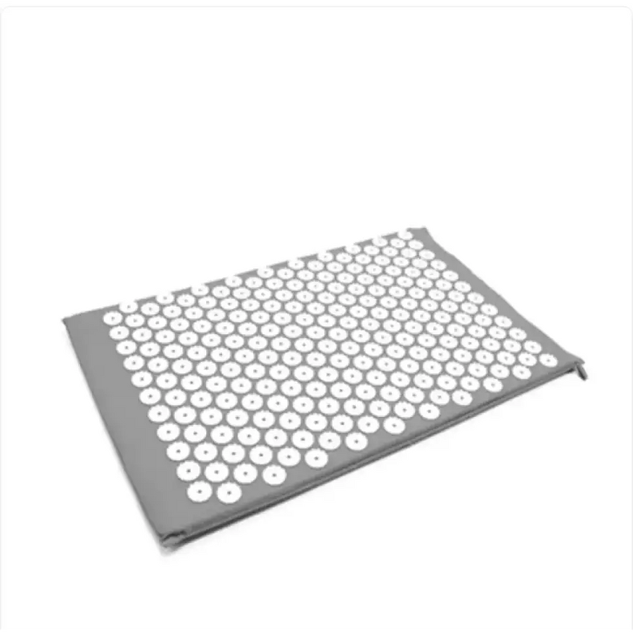 Gray massage mat with a grid of white acupressure needles.