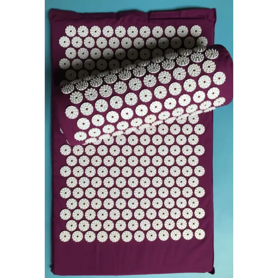 Purple acupressure mat with white circular spikes arranged in a grid pattern.