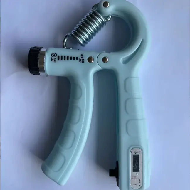 Light blue plastic hand gripper with a metal spring and adjustable resistance scale marked in kilograms.