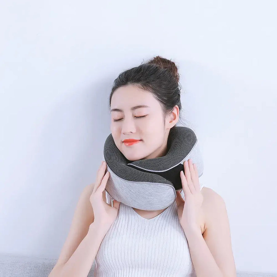 Gray and black ergonomic neck pillow with soft fabric exterior.