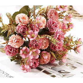 A delicate bouquet of artificial pink and peach-colored flowers with green leaves, arranged in a naturalistic cluster.