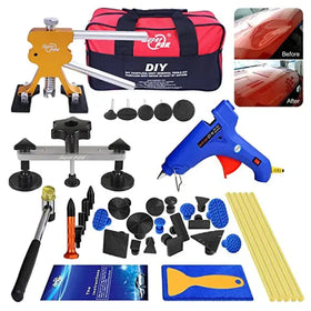 Orange and silver diy paintless dent repair tool kit with black suction cups, blue glue gun, and assorted plastic and rubber patches.