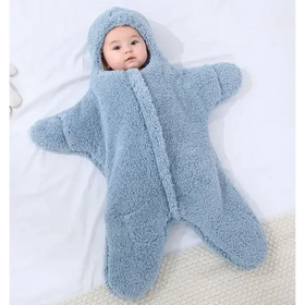 A soft, light blue star-shaped baby sleeper made of plush fleece material with a hood and zipper front.