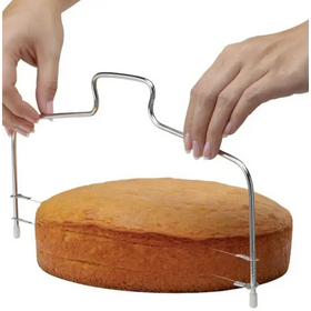 Silver metal cake slicer with a curved handle and adjustable legs for precise cutting.