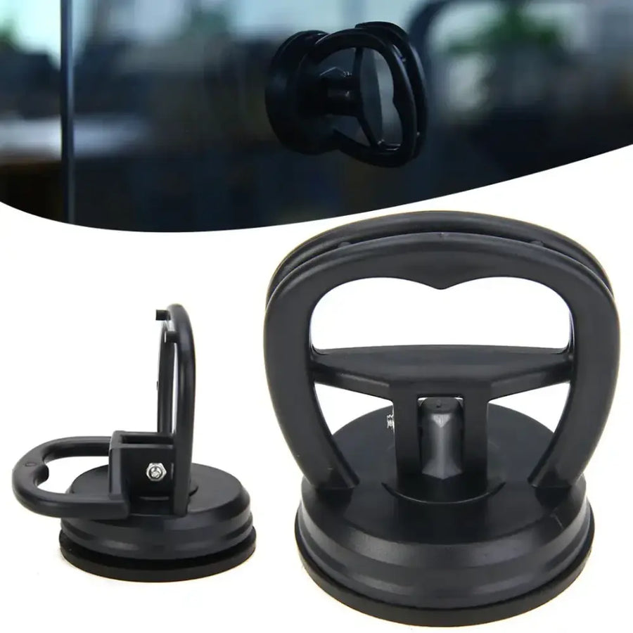 Black plastic suction cup window removal tool with a sturdy handle and adjustable grip.