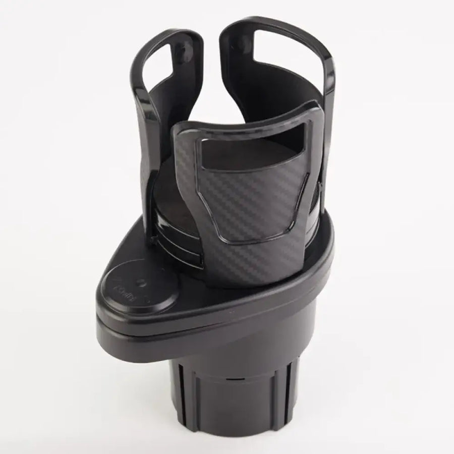 Black plastic car cup holder with a carbon fiber textured insert and two curved handles.
