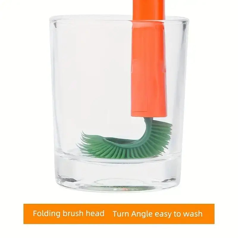 Orange-handled, green silicone folding brush head designed for easy cleaning and storage.