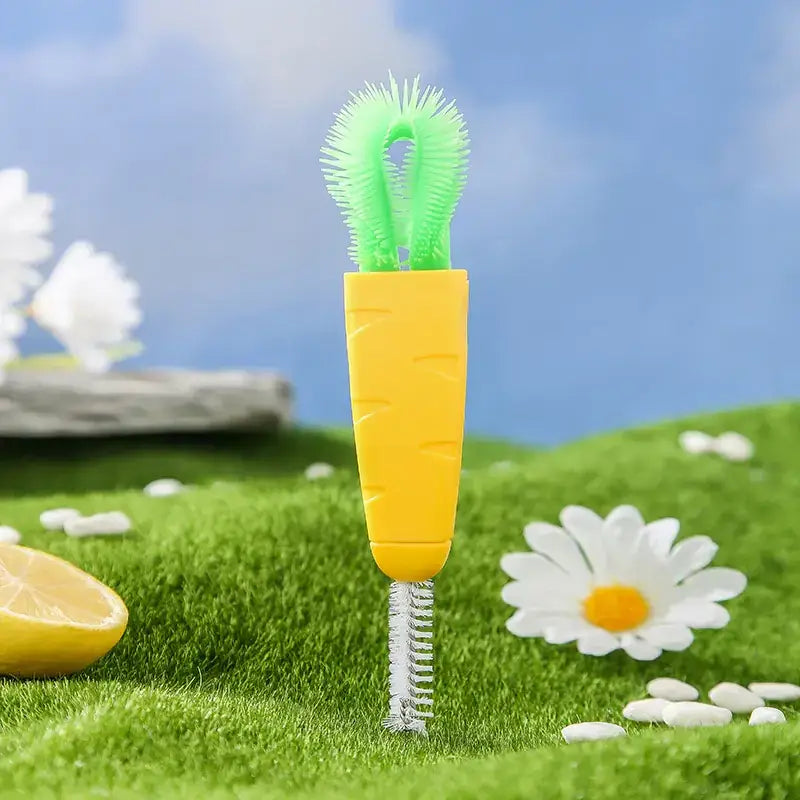 A bright yellow and green carrot-shaped bottle brush with a soft bristle head for cleaning bottles.