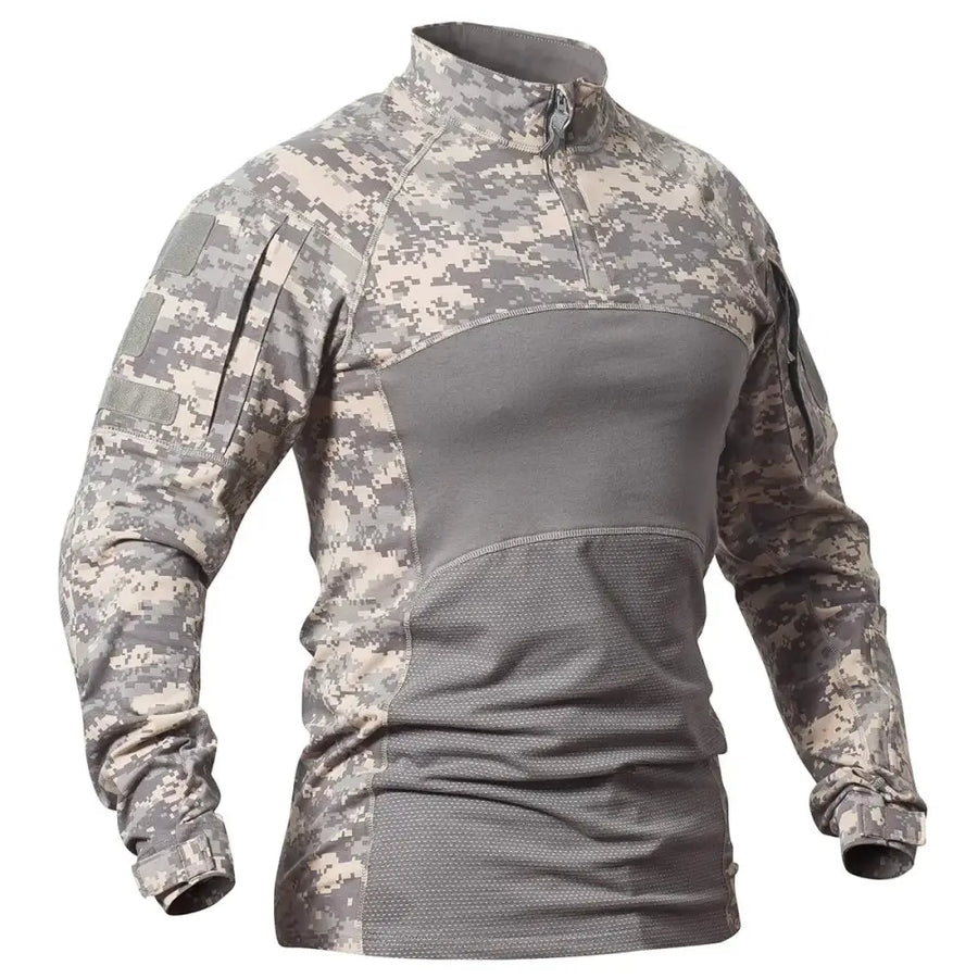 A tactical long-sleeve shirt in digital camouflage with gray and beige patterns, featuring a half-zip collar, reinforced panels on the torso for durability, and adjustable cuffs.