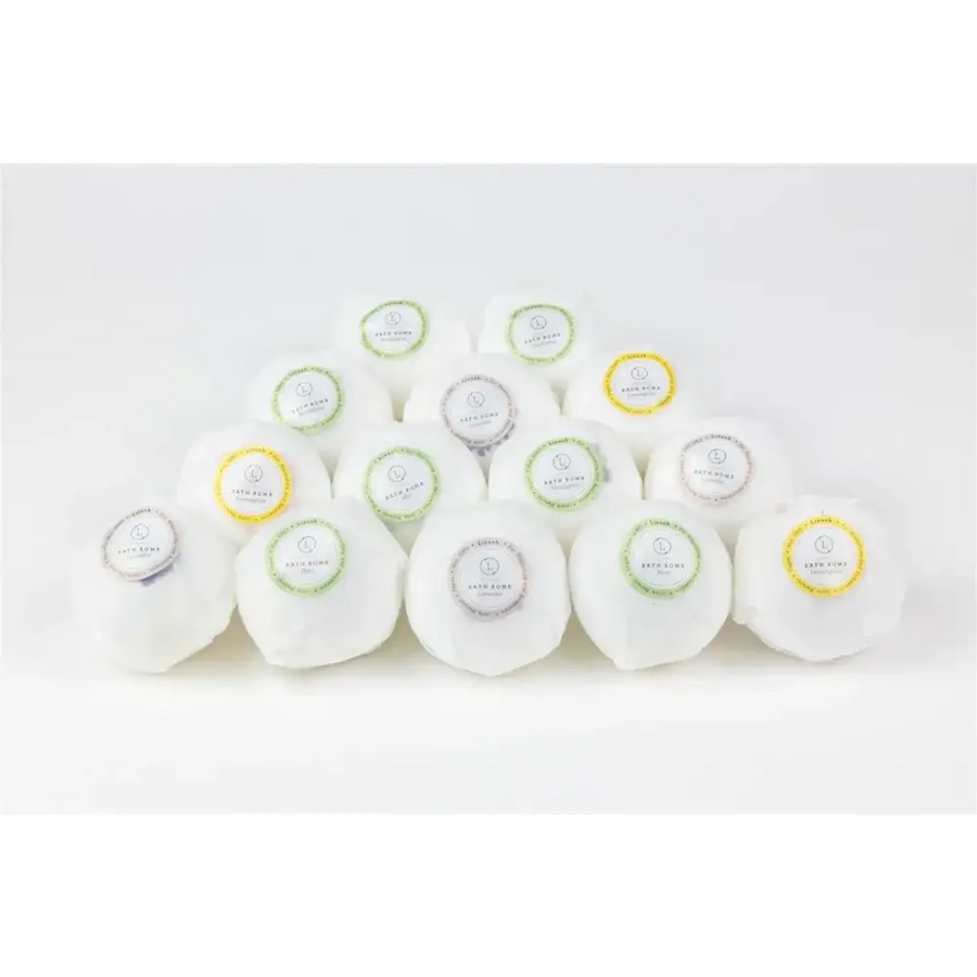 White bath bombs with colorful circular labels in green, yellow, and silver.