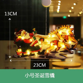 A festive illuminated santa claus sleigh with reindeer, crafted from translucent material and adorned with warm glowing lights.
