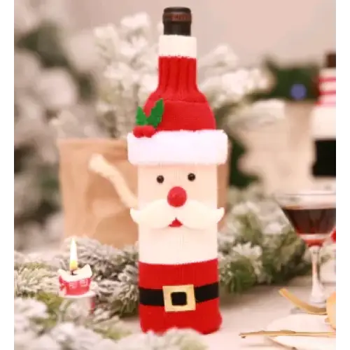 Red and white knitted santa claus bottle cover with a black belt, red nose, and green holly accents.