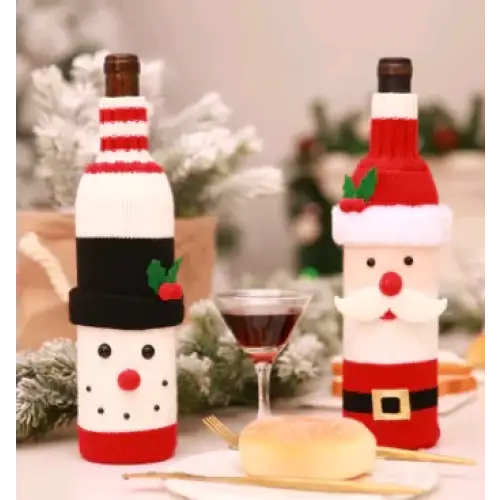 Red and white knitted wine bottle covers featuring snowman and santa claus designs.