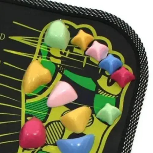 Colorful, glossy plastic toe-shaped stimulators arranged on a black foot按摩垫 with yellow and green graphic design.
