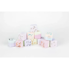 Pastel-colored bath bombs with speckled and layered designs.