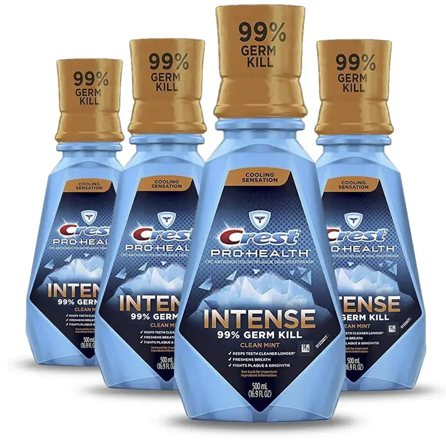 Blue plastic bottles of crest pro-health intense cool mint mouthwash with gold caps and icy blue label design.