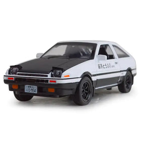White and black diecast model of a toyota ae86 with ’藤原とうふ店’ lettering on the side.