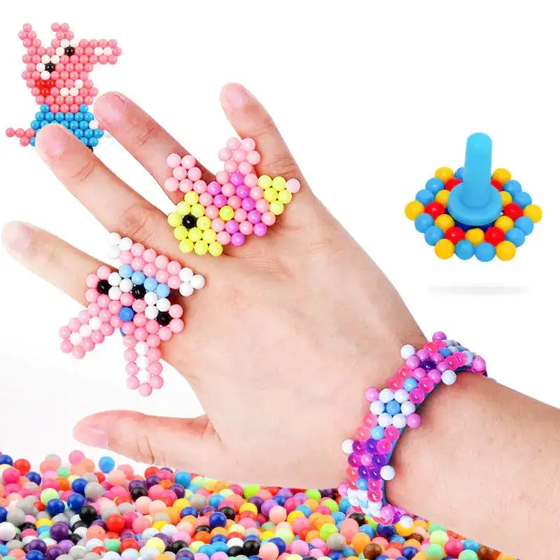 Colorful plastic bead crafts shaped like a pig, butterfly, and rabbit adorn fingers and wrist.