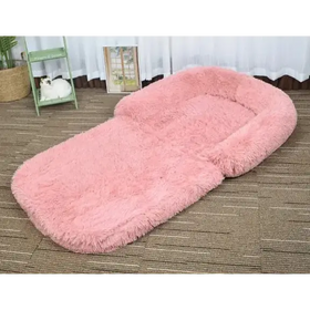 Pink fluffy pet bed with a soft, plush texture and rounded edges.