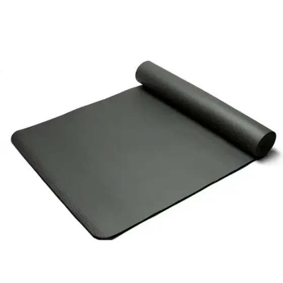 Black rubber yoga mat, partially rolled up with a textured surface.