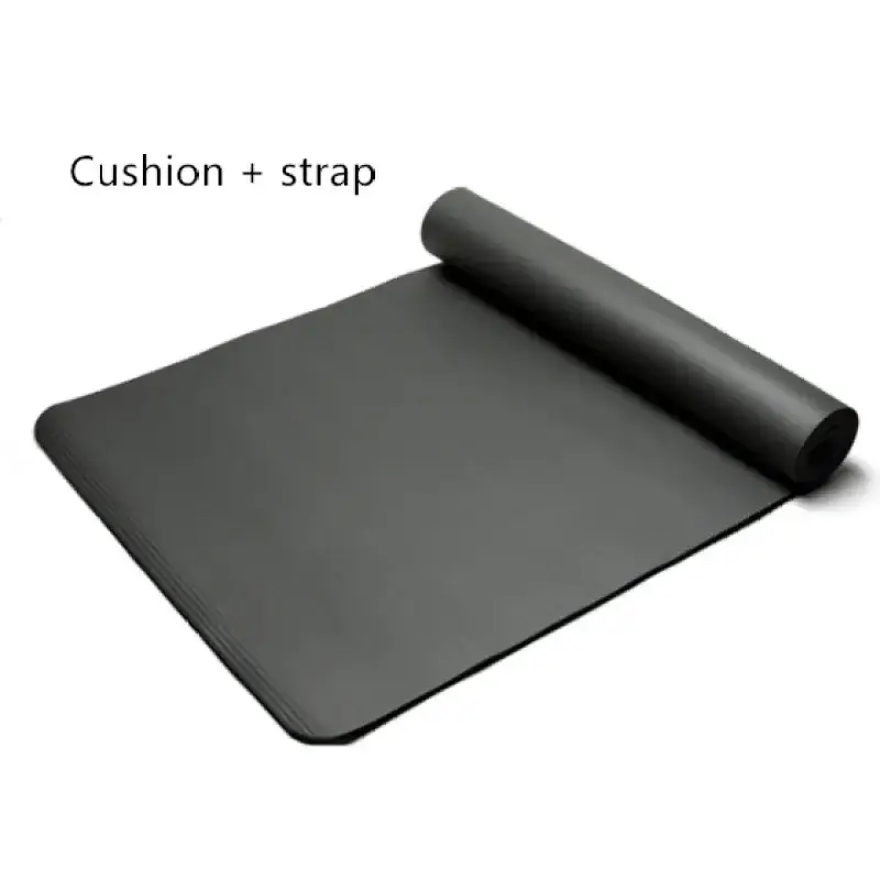 Black yoga mat with a rolled-up section revealing its cushioned surface and integrated strap.