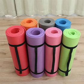 A set of colorful, rolled yoga mats in vibrant hues including red, purple, pink, green, orange, and blue, each secured with a black strap.