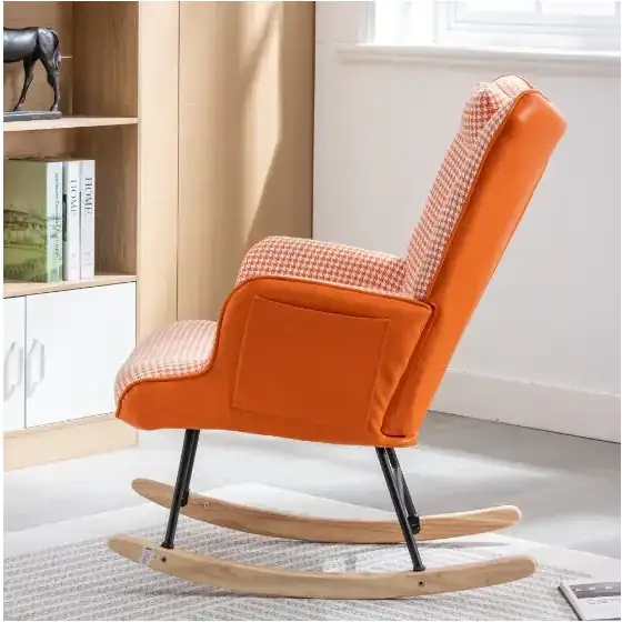 Orange upholstered rocking chair with a houndstooth pattern on the backrest and seat, featuring wooden rockers and black metal legs.