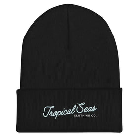 Black knit beanie with a folded cuff featuring white embroidered text reading ’tropical seas clothing co.’