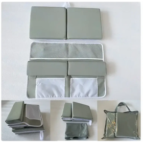 Gray fabric baby changing pad with mesh and solid panel sections.