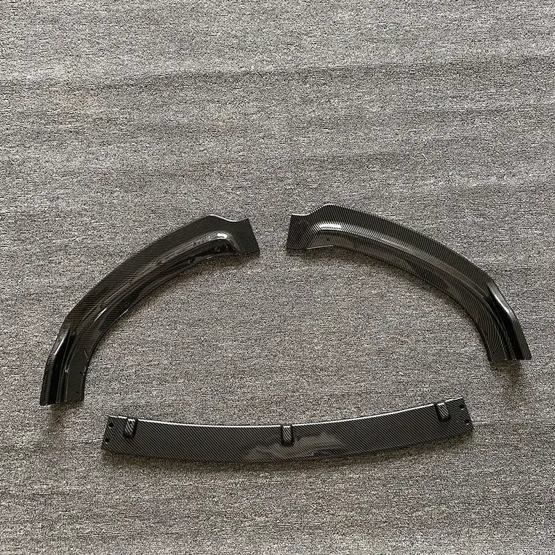 Black carbon fiber fender flares with a glossy finish and reinforced mounting brackets.