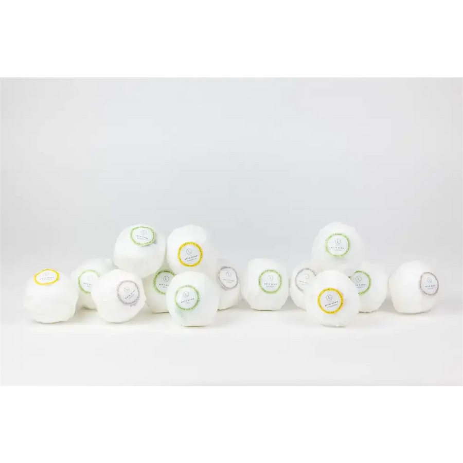 White spherical bath bombs with colorful circular labels.