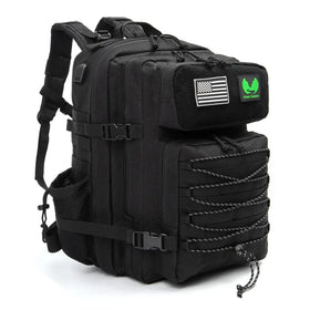 Black tactical backpack with reinforced straps, multiple compartments, and a green ’green canyon’ patch on the top flap.