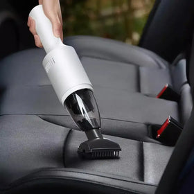 White and black handheld car vacuum cleaner with a transparent dust collection chamber.