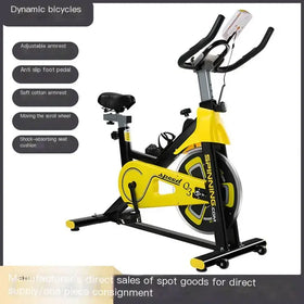 Yellow and black spinning.com speed q3 exercise bike with adjustable armrests, anti-slip pedals, soft cotton armrest, moving scroll wheel, and shock-absorbing seat cushion.