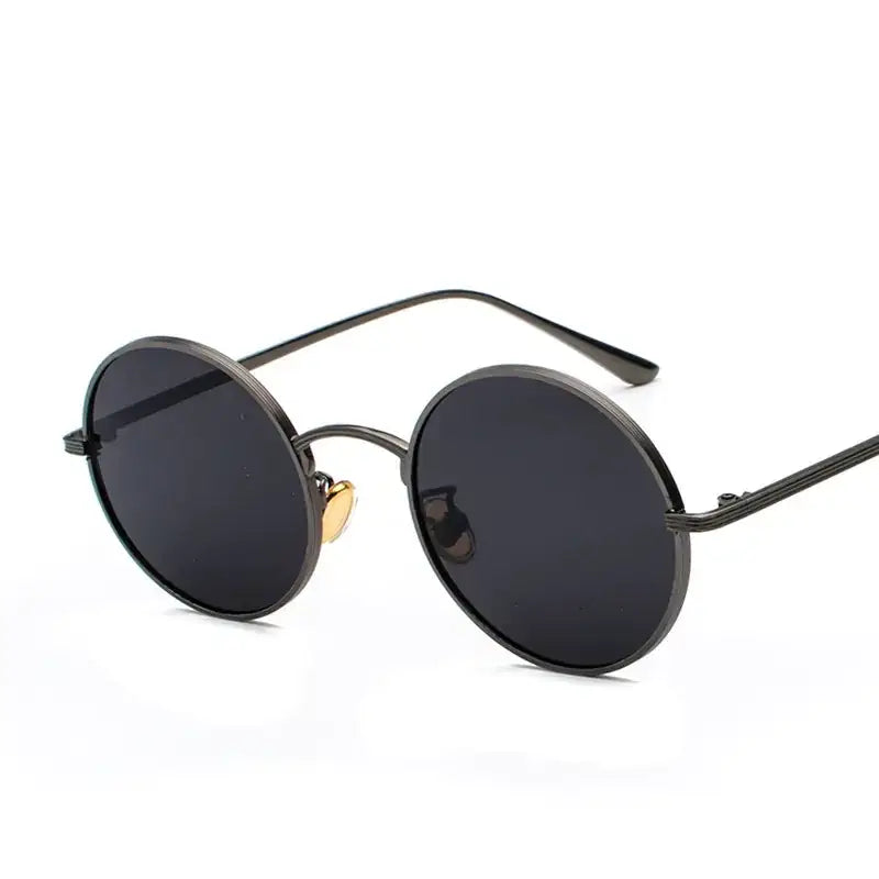 Black round sunglasses with dark lenses and a gold-colored nose bridge.