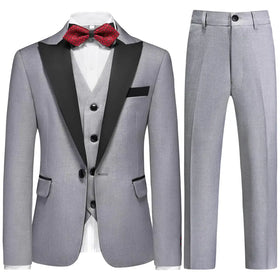 Gray tuxedo suit with black satin lapels and matching vest, accented by a red patterned bow tie.