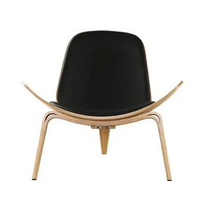 Black leather upholstered lounge chair with curved light wood frame.