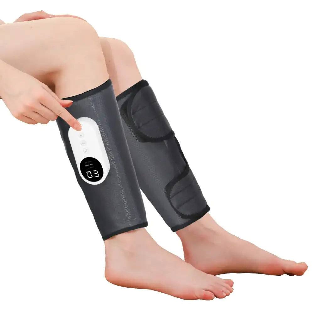 Black fabric leg massager with a white control panel and digital display