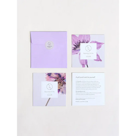 Lavender envelope with circular silver logo seal