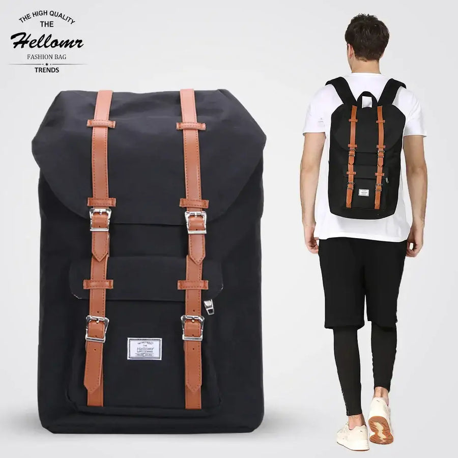 Black canvas backpack with tan leather straps and silver buckles, featuring a classic retro design.