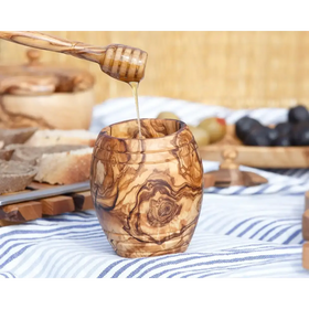 Hand-carved olive wood honey jar with swirling brown and tan patterns.