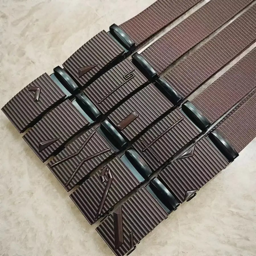 Brown woven belt with black plastic buckle featuring embossed geometric designs.
